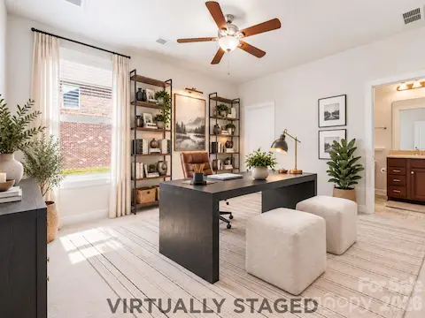 A Sophisticated Work-From-Home Space | Virtually Staged — Or reimagine the same room as an impressive private home office, with ample space for a substantial desk, library-style shelving, and additional seating. Its first-floor location creates separation between work and the home's primary living spaces, while the nearby full bath preserves the flexibility to convert the room back to guest accommodations whenever needed.