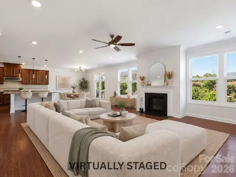 Virtually staged to show the possibilities, the open family room is made for movie nights, relaxed weekends, and time spent together by the fireplace.