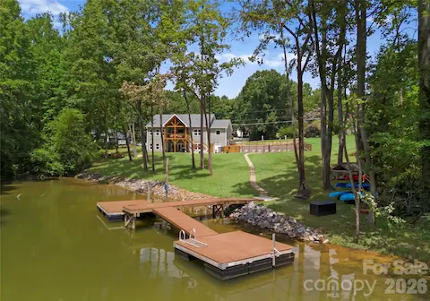 A private dock invites you to spend the day on the water, while the tree-lined lawn creates a beautiful setting between the home and shoreline.