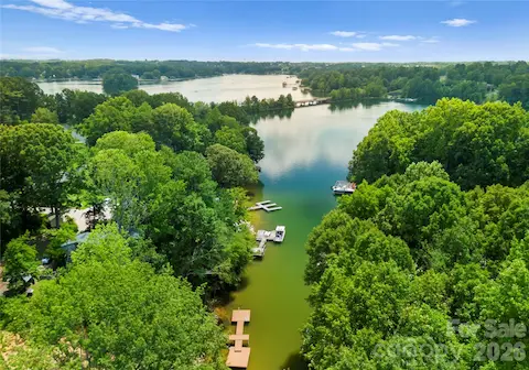Tucked along a wooded cove, the property offers a peaceful waterfront setting with the open waters of Lake Norman just beyond.