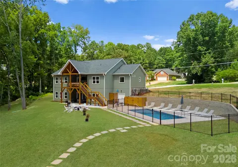 From the covered porch to the fenced pool, the backyard is designed for long afternoons outside and easy entertaining.