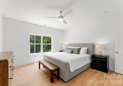 Enjoy this serene and tranquil primary bedroom with stunning views of the lake.