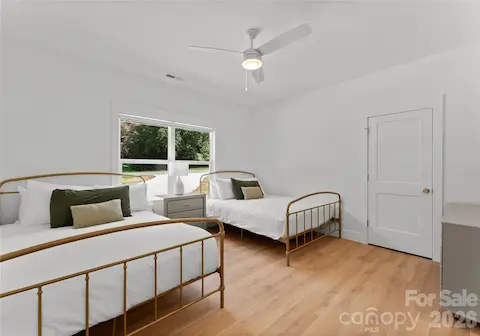 This light-filled bedroom offers two beds and an easy, welcoming place for guests to settle in.
