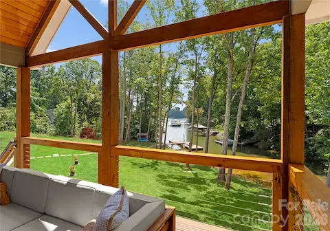 Timber framing draws the eye across the lawn to the dock and quiet cove—a beautiful backdrop for relaxing on the covered porch.