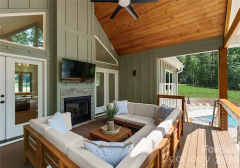 With a fireplace, comfortable seating, and the pool just steps away, this covered porch feels like an extension of the living space.