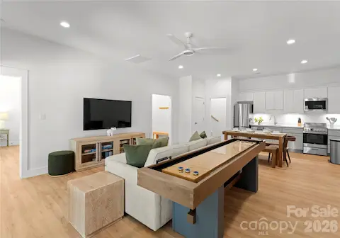 A shuffleboard table gives this spacious lounge a playful touch and another place for guests to gather.