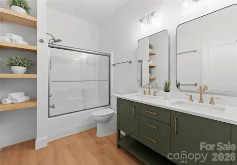 A double vanity, open shelving, and a tub-shower combination make this bathroom both polished and practical.
