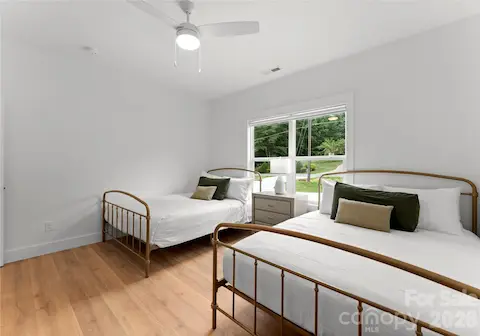 Two beds and a large window make this bedroom a comfortable retreat.