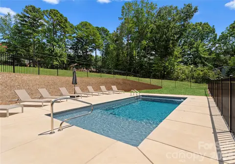 Relax beside the pool with room for multiple loungers and views of the surrounding greenery.