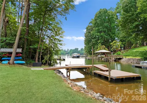 The dock sits along a quiet, tree-lined cove, with space to relax by the water and enjoy the lake.